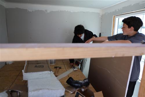 Student's working on window framing.