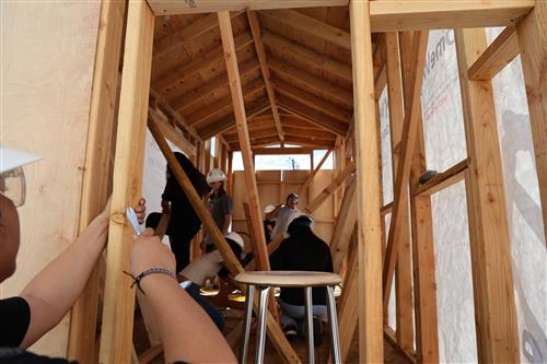 Students working hard to prepare the home for siding.