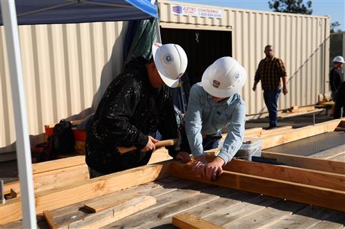 Students working on floor joists of the tiny home.