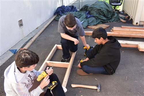 Students working on loft bed fram.