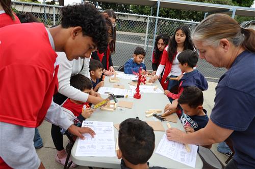 Students hard at work building a bird house with the help of the Home Deopt Crew, Leadership students and wood shop students.