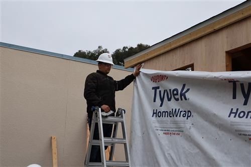 Students helping to install the moister barrier.