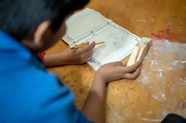 Student making the sketch for the Tiny Home project