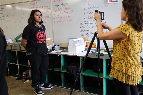 Woodshop student being interviewed by CBS news.