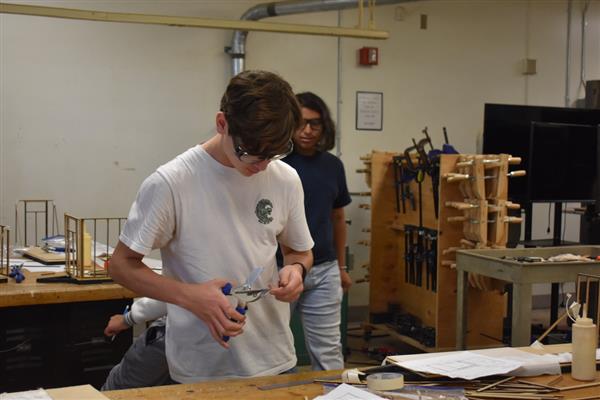 Students working on tiny home model.