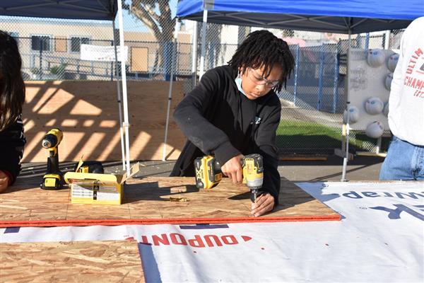 Students working on installing the subfloor.