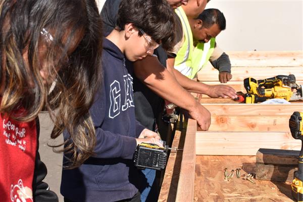 Students working on installing the subfloor.