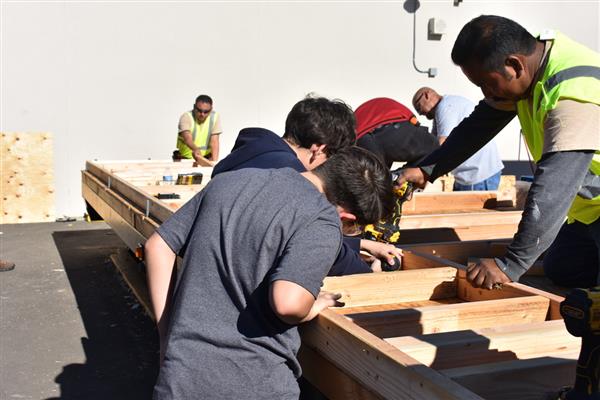 Students working on installing the subfloor.