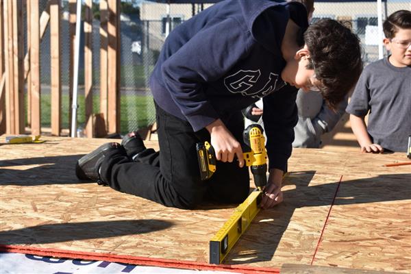 Students working on installing the subfloor.