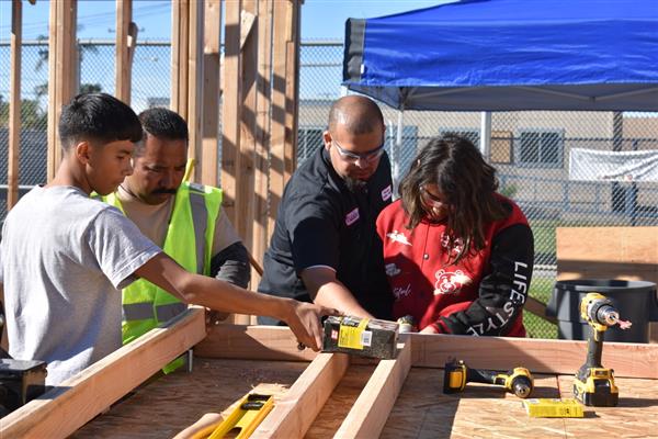 Students working on installing the subfloor.