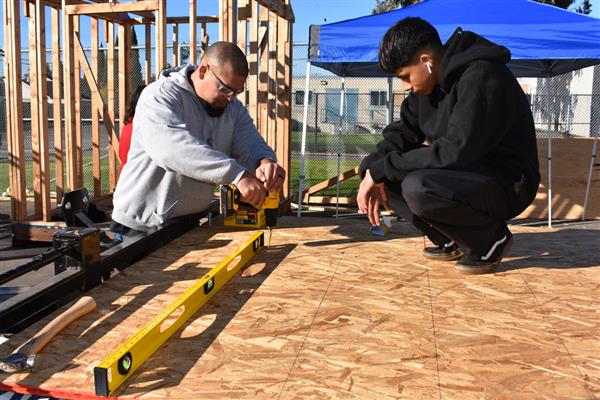 Students working on installing the subfloor.