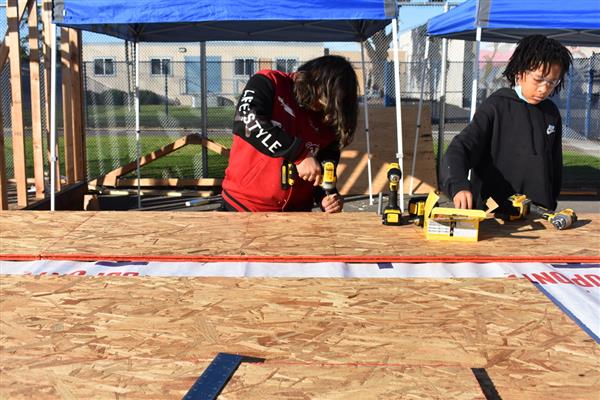 Students working on installing the subfloor.