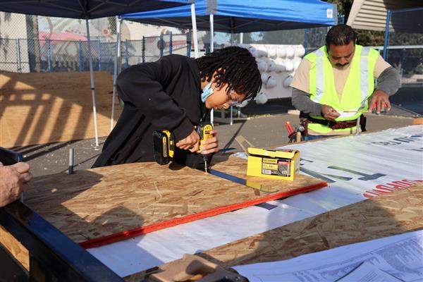 Students working on installing the subfloor.