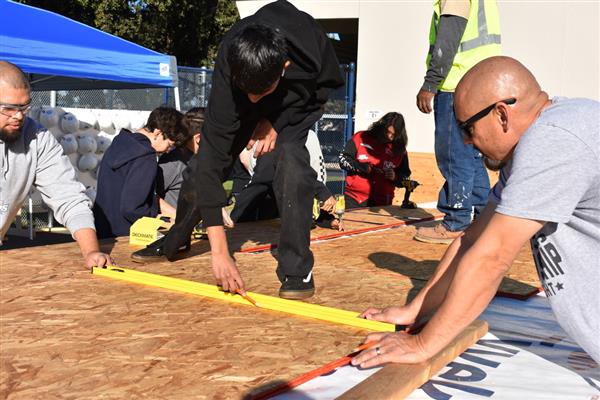 Students working on installing the subfloor.