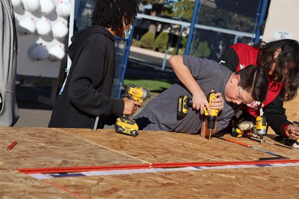 Students working on installing the subfloor.