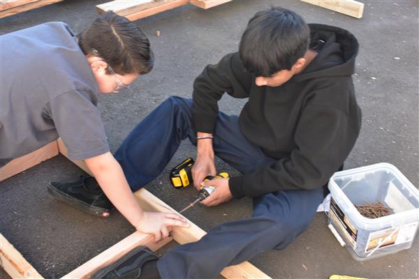 Screwing window frames together.