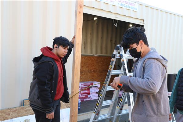 Measuring before they cut the wood.