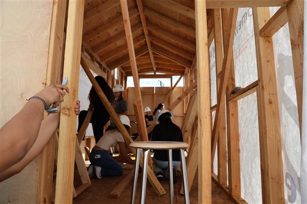 Students worked on adding wall sheathing to the framing.