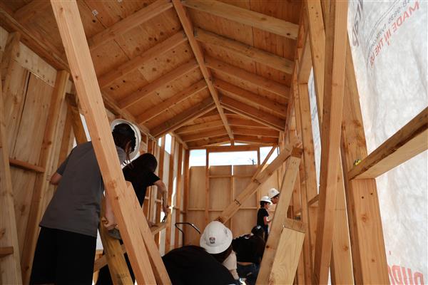 Students worked on adding wall sheathing to the framing.