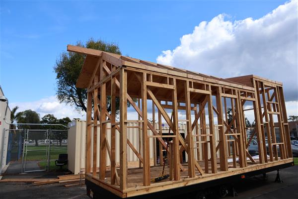 Tiny home frame and roof rafters complete, now working on putting plywood up for the roof.