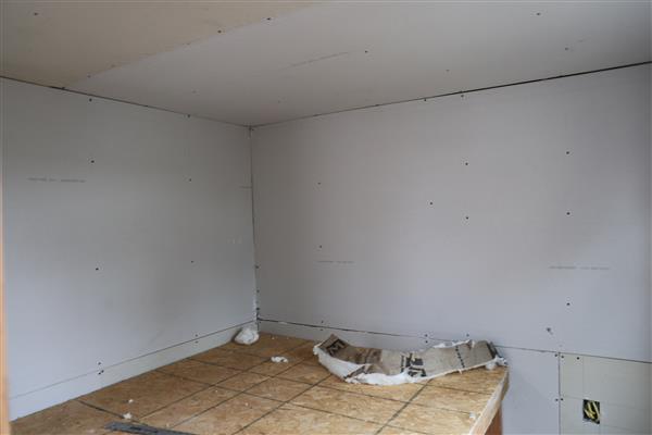 Drywall has been installed and is ready to be taped and textured.