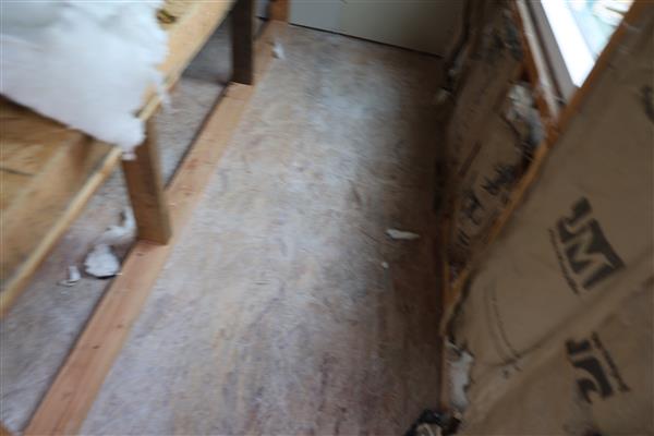 Students working on insulation and preparing for drywall.