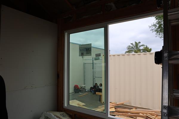 Large picture window installed in common area and ready for framing.