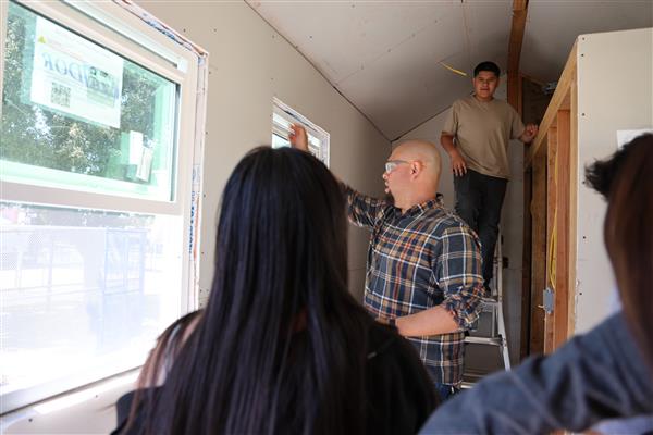 Mr. Vidales showing the students how to frame the window.