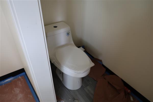 Toilet is ready to use in the bathroom.