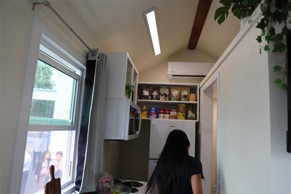 The kitchen and hallway leading to the bathroom.